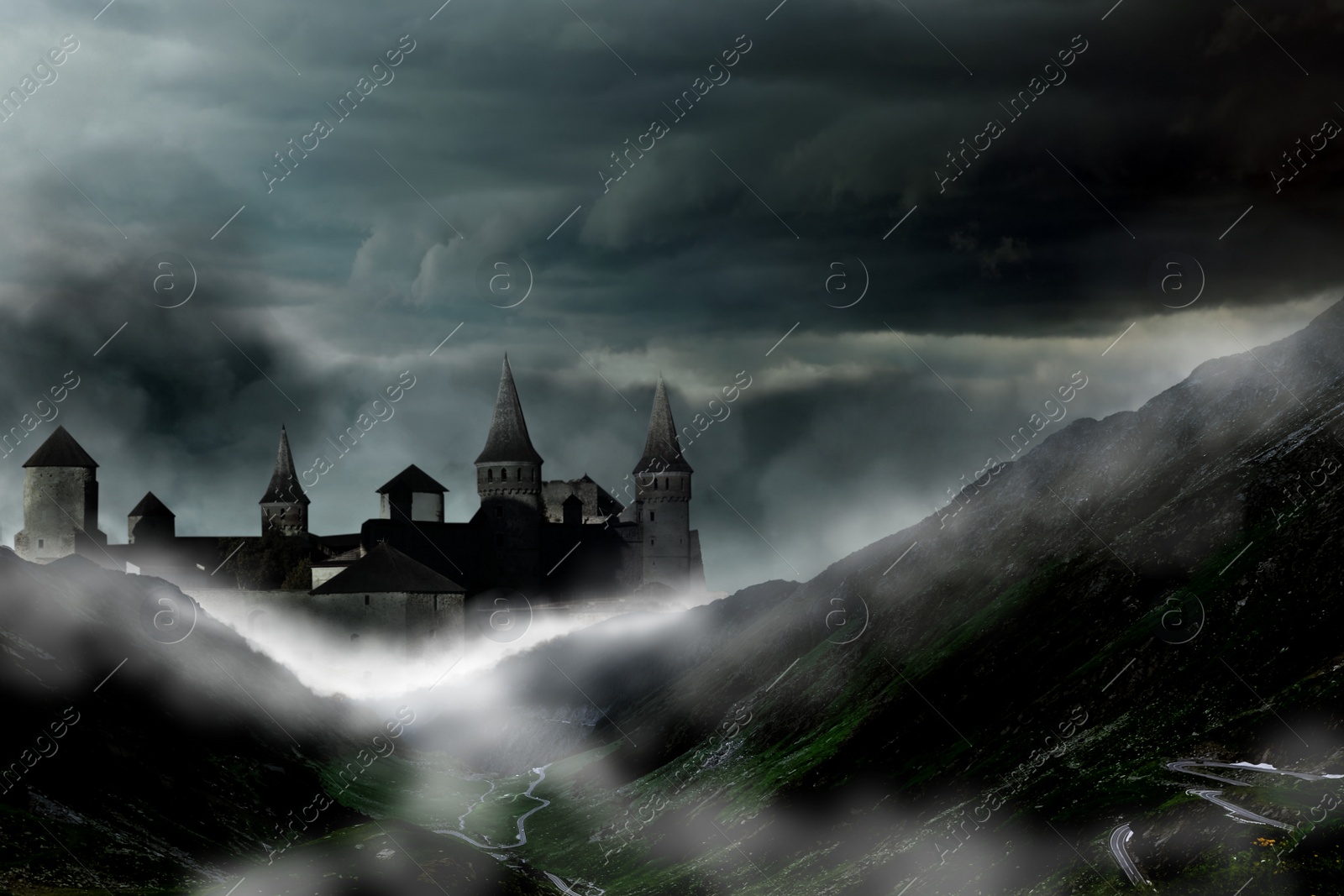 Image of Fantasy world. Mystical castle and mountains covering with fog in night