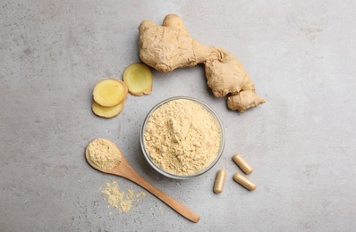 Dry, fresh and capsuled ginger on grey table, flat lay