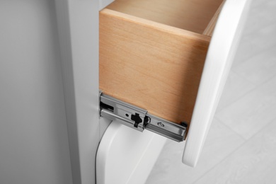 Photo of Open chest of drawers indoors, closeup view