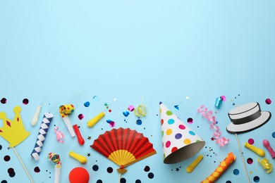 Photo of Flat lay composition with carnival items on light blue background. Space for text