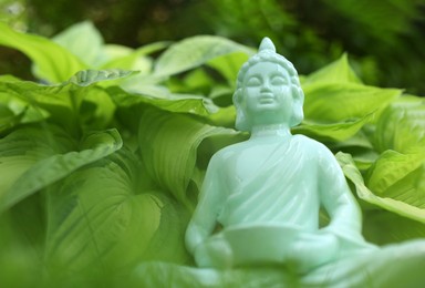 Decorative Buddha statue outdoors, closeup. Space for text