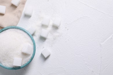 Different types of sugar in bowl on white table, flat lay. Space for text