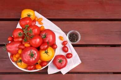 Photo of Bowls with fresh tomatoes and spices on wooden table, flat lay. Space for text