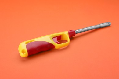 One bright gas lighter on orange background