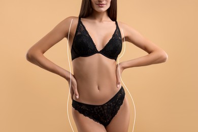Image of Woman showing her beautiful figure on dark beige background, closeup. Her body outline before cosmetic treatment