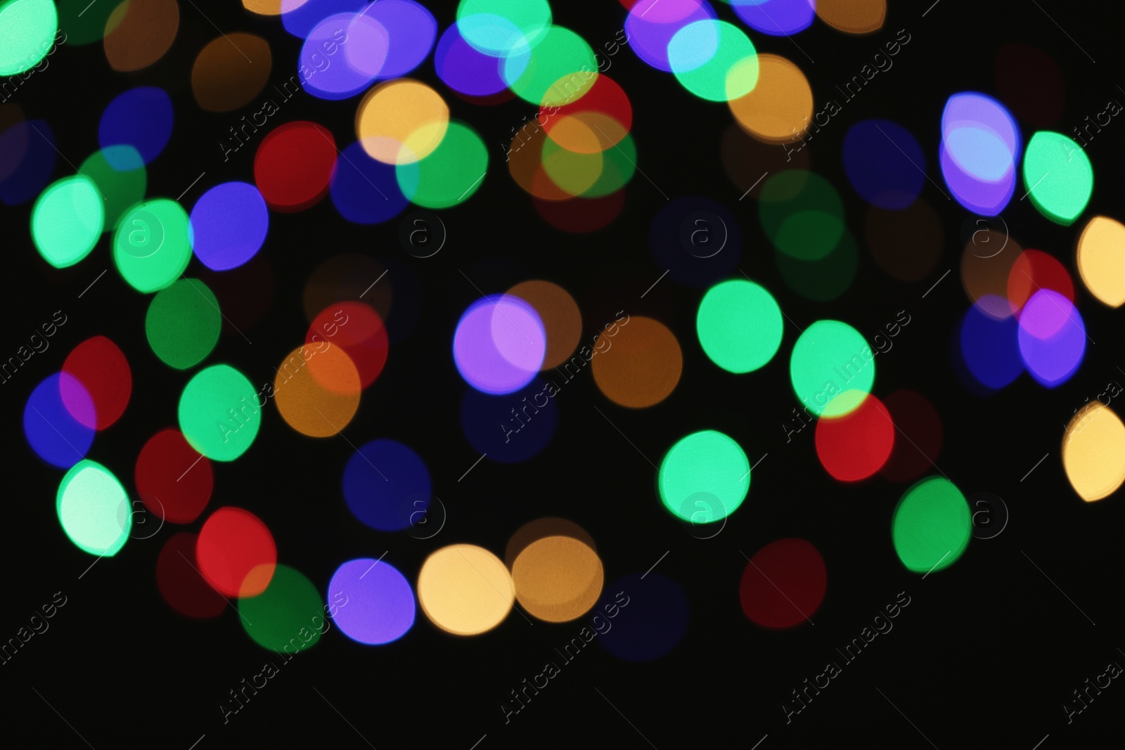 Photo of Beautiful colorful lights on dark background. Bokeh effect