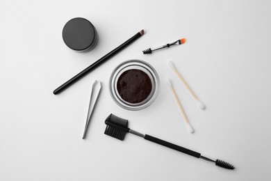 Photo of Flat lay composition with eyebrow henna and professional tools on white background