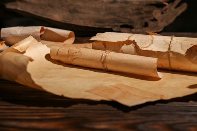Sheets of old parchment paper on wooden table