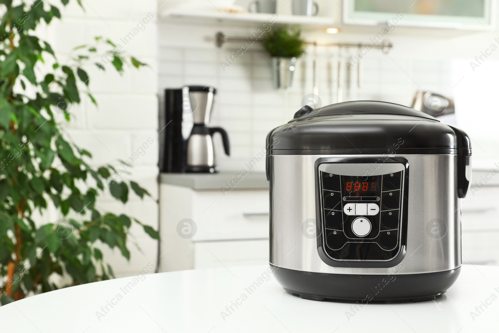 Photo of Modern multi cooker on table in kitchen. Space for text