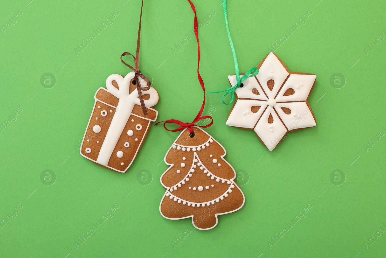 Photo of Different delicious Christmas cookies on green background, flat lay