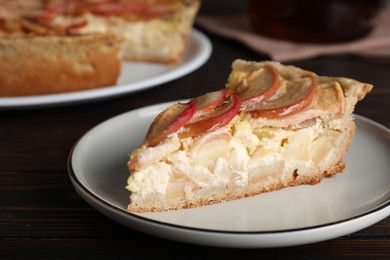 Photo of Piece of delicious homemade apple pie on wooden table, closeup