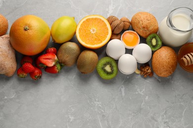 Allergenic food. Different fresh products on gray marble table, top view. Space for text