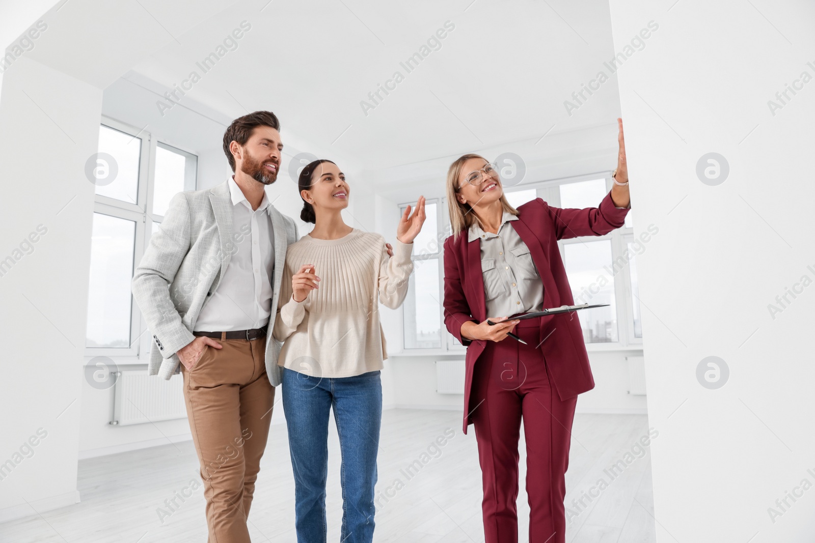 Photo of Real estate agent showing new apartment to couple