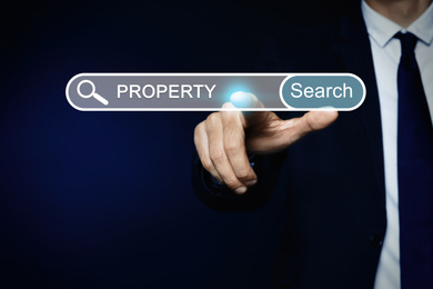 Image of Property search concept. Man using virtual screen with search bar, closeup