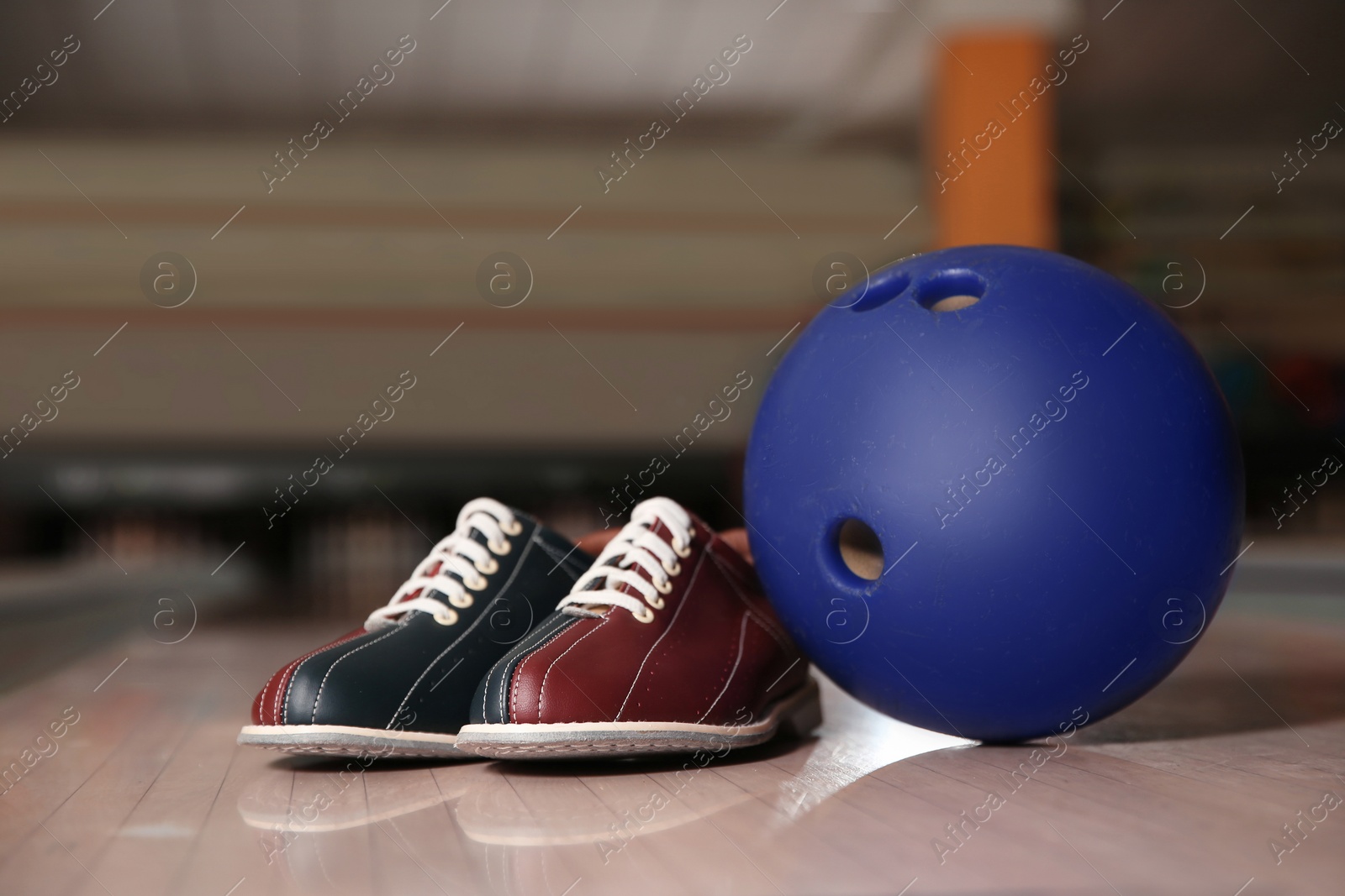 Photo of Shoes and ball on bowling lane in club