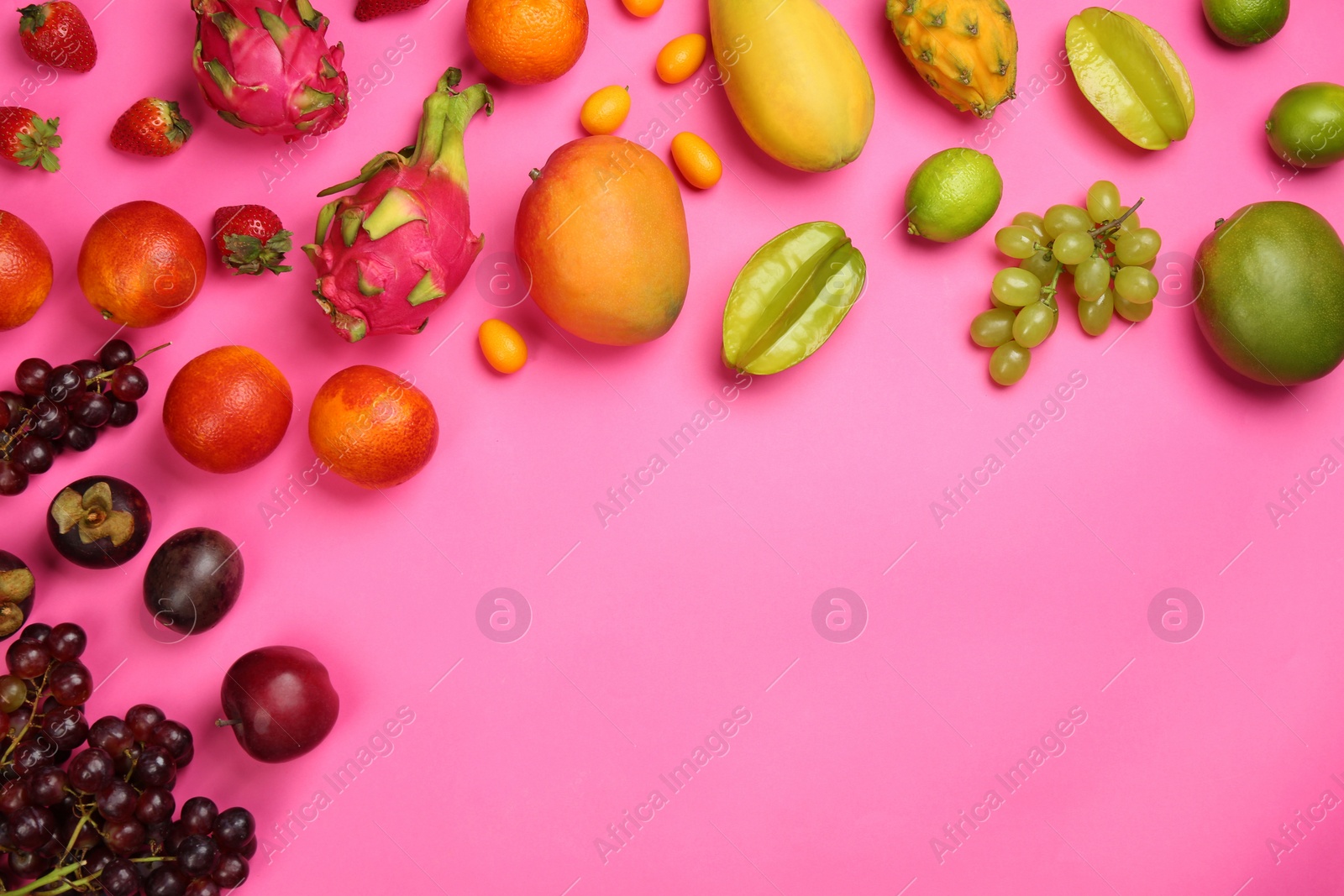 Photo of Many different delicious exotic fruits on pink background, flat lay. Space for text