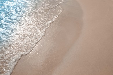 Photo of Sea waves rolling onto sandy tropical beach