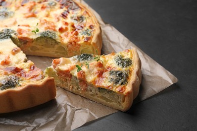 Delicious homemade quiche with salmon and broccoli on parchment paper