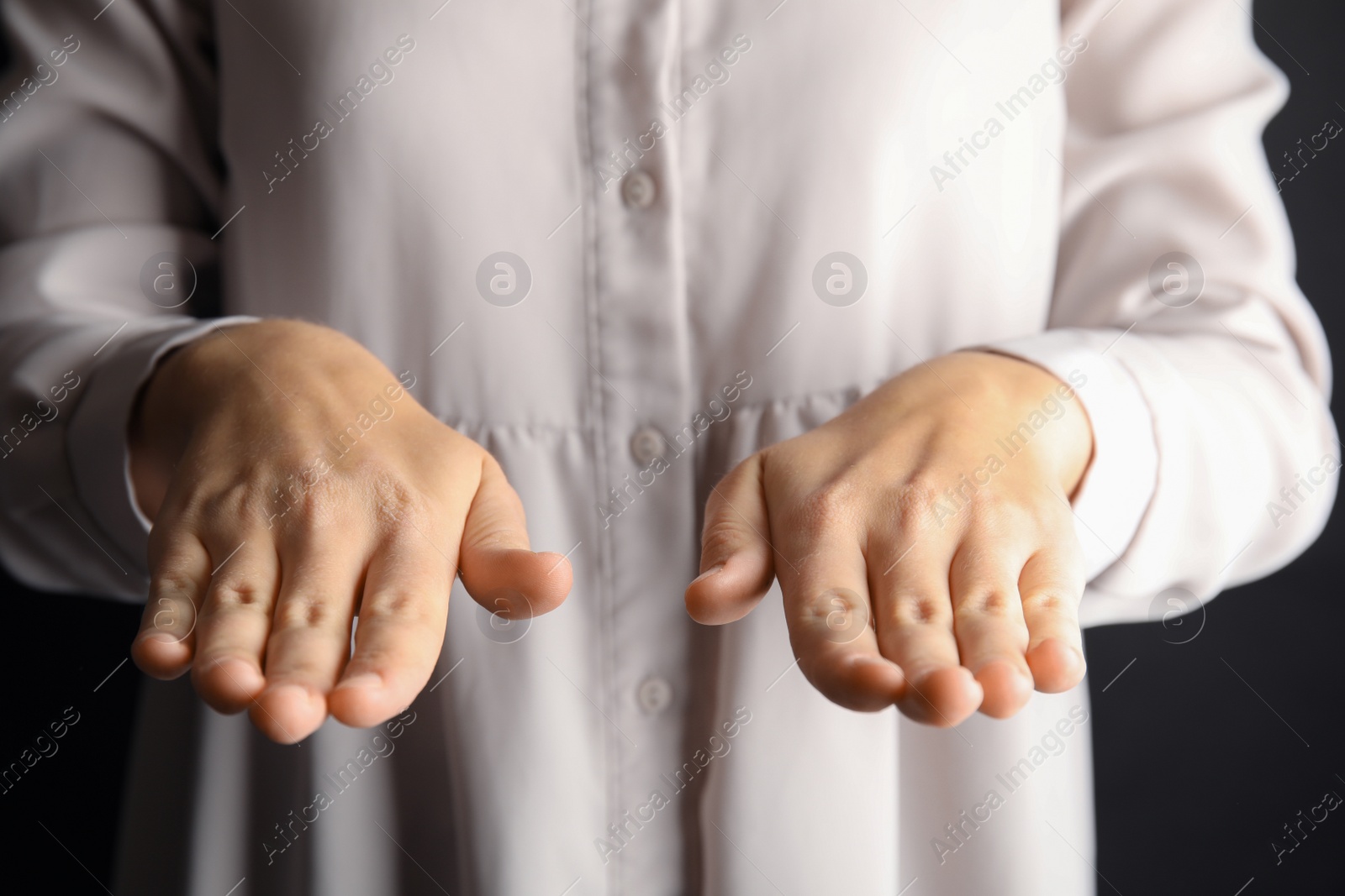 Photo of Woman showing word bless, closeup. Sign language