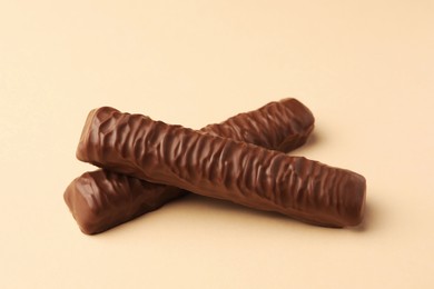 Photo of Sweet tasty chocolate bars on beige background