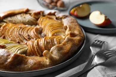 Delicious galette with apples served on grey table, closeup