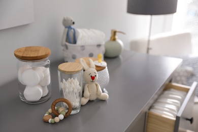 Baby accessories and toys on table in room