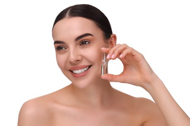 Beautiful young woman holding skincare ampoule on white background