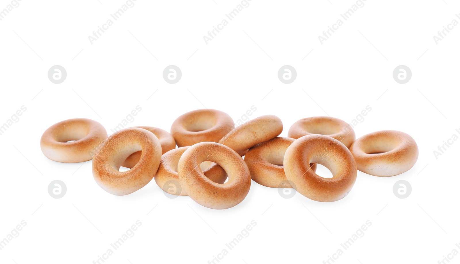 Photo of Pile of tasty dry bagels (sushki) on white background