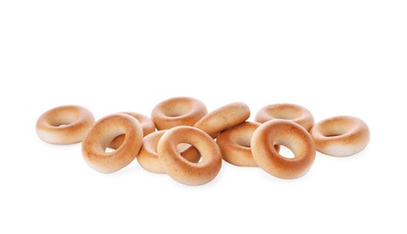 Pile of tasty dry bagels (sushki) on white background