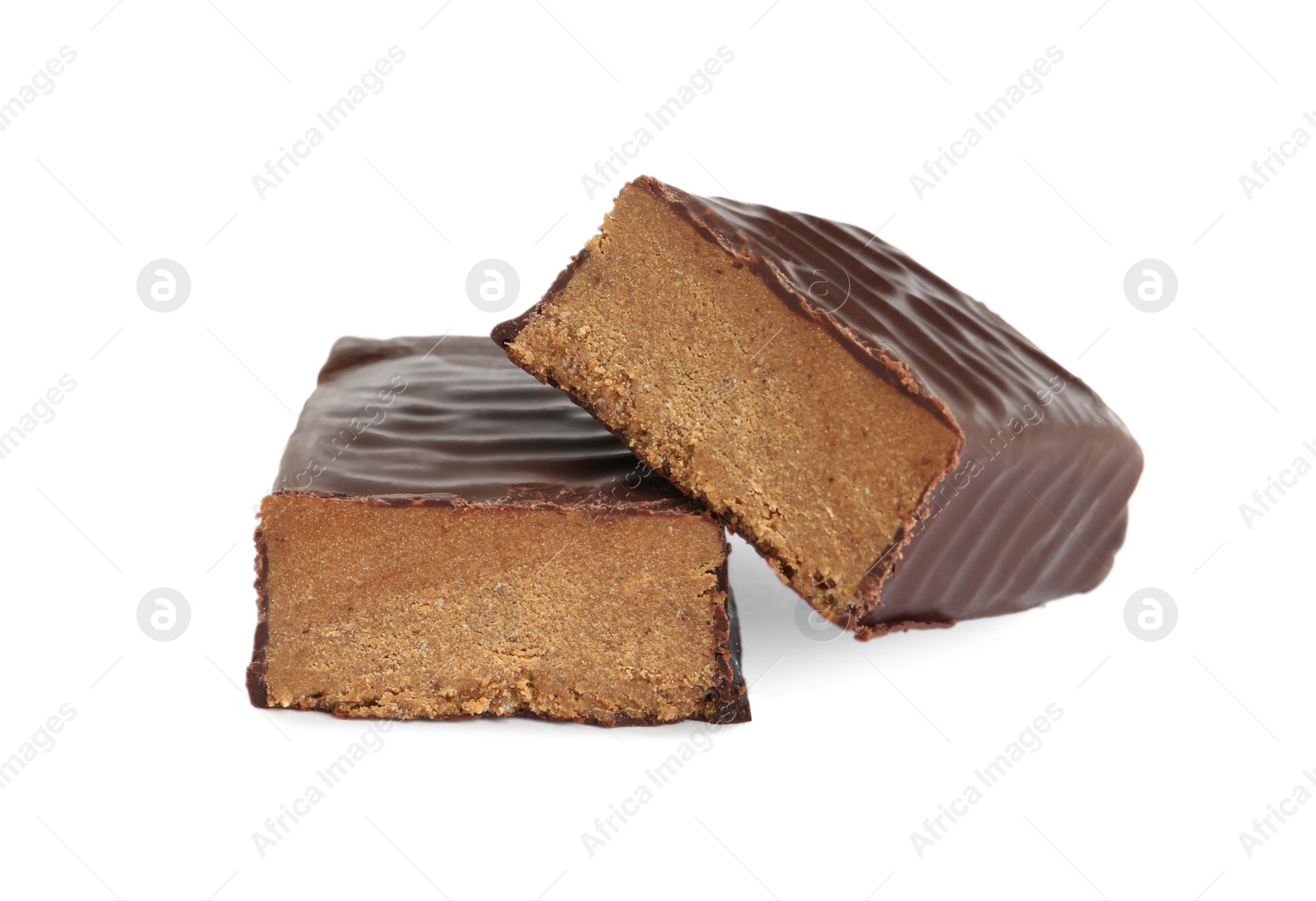 Photo of Halves of tasty chocolate glazed protein bar on white background