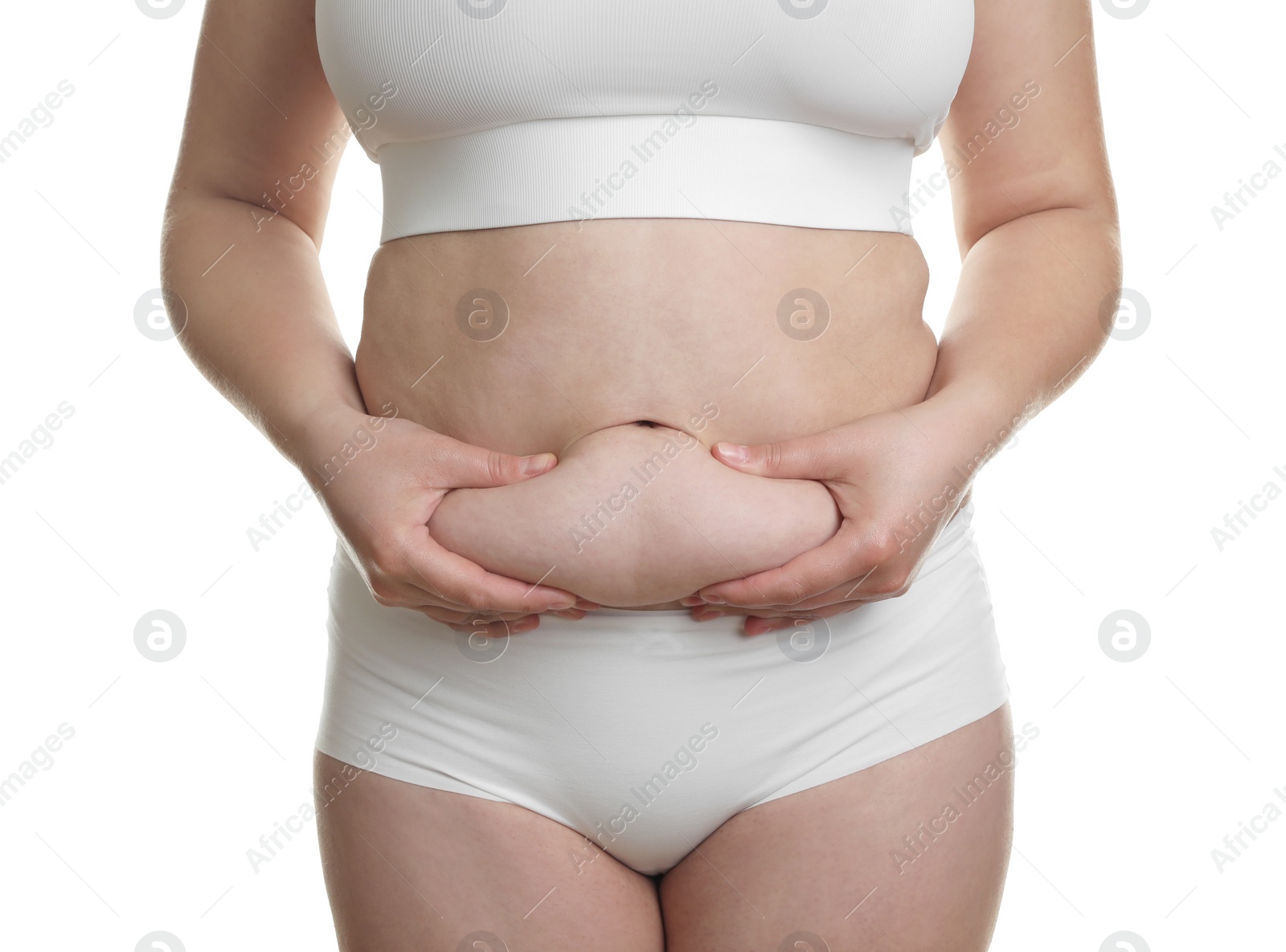 Photo of Woman touching belly fat on white background, closeup. Overweight problem