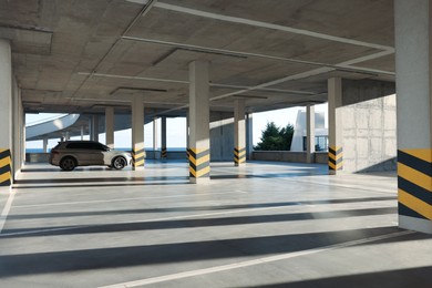 Photo of Open parking garage with car on sunny day