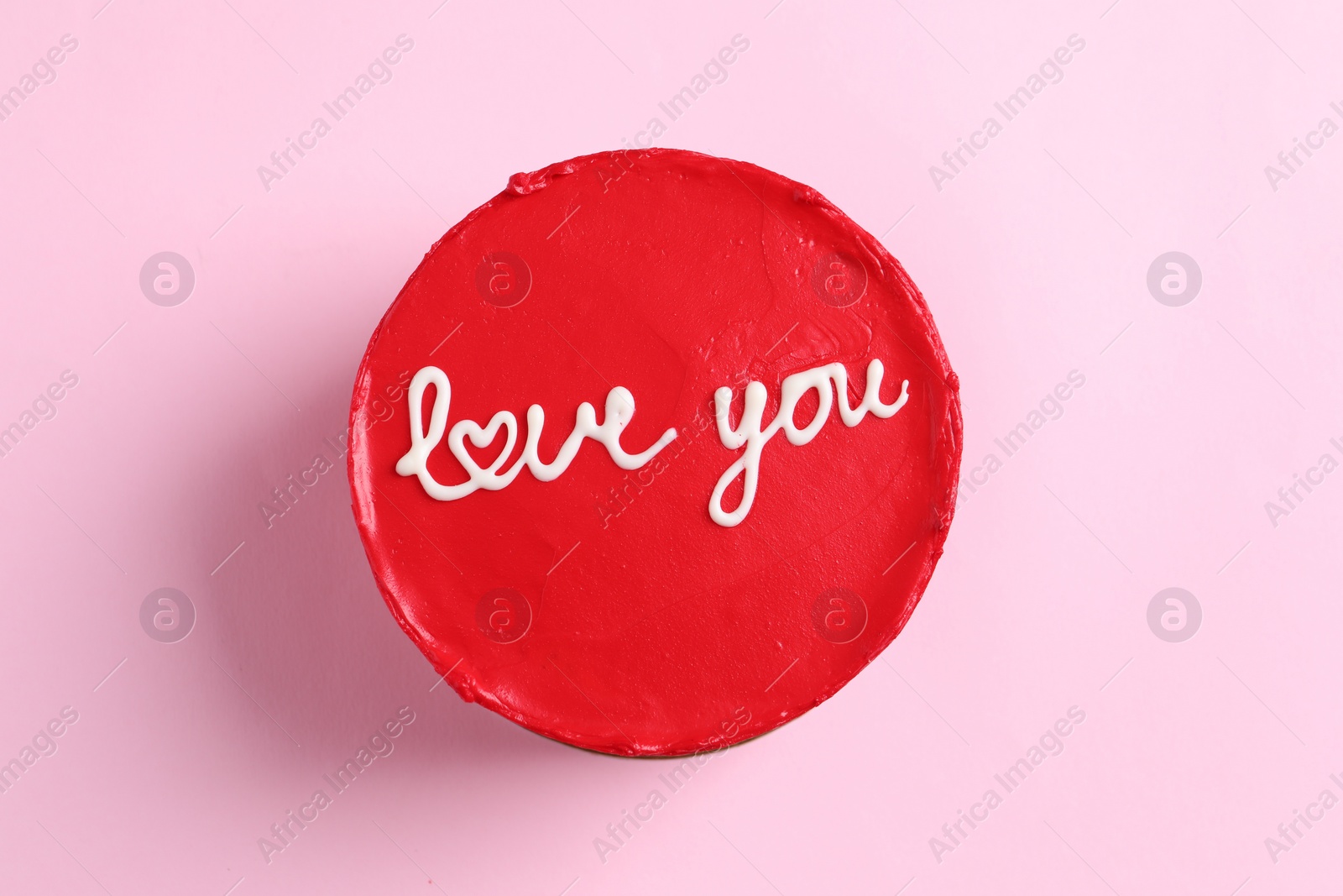 Photo of Bento cake with text Love You on pink table, top view. St. Valentine's day surprise