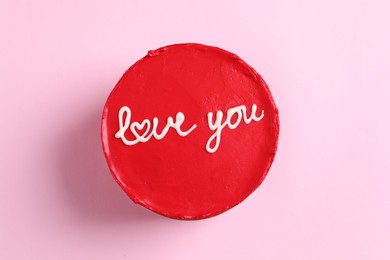 Photo of Bento cake with text Love You on pink table, top view. St. Valentine's day surprise