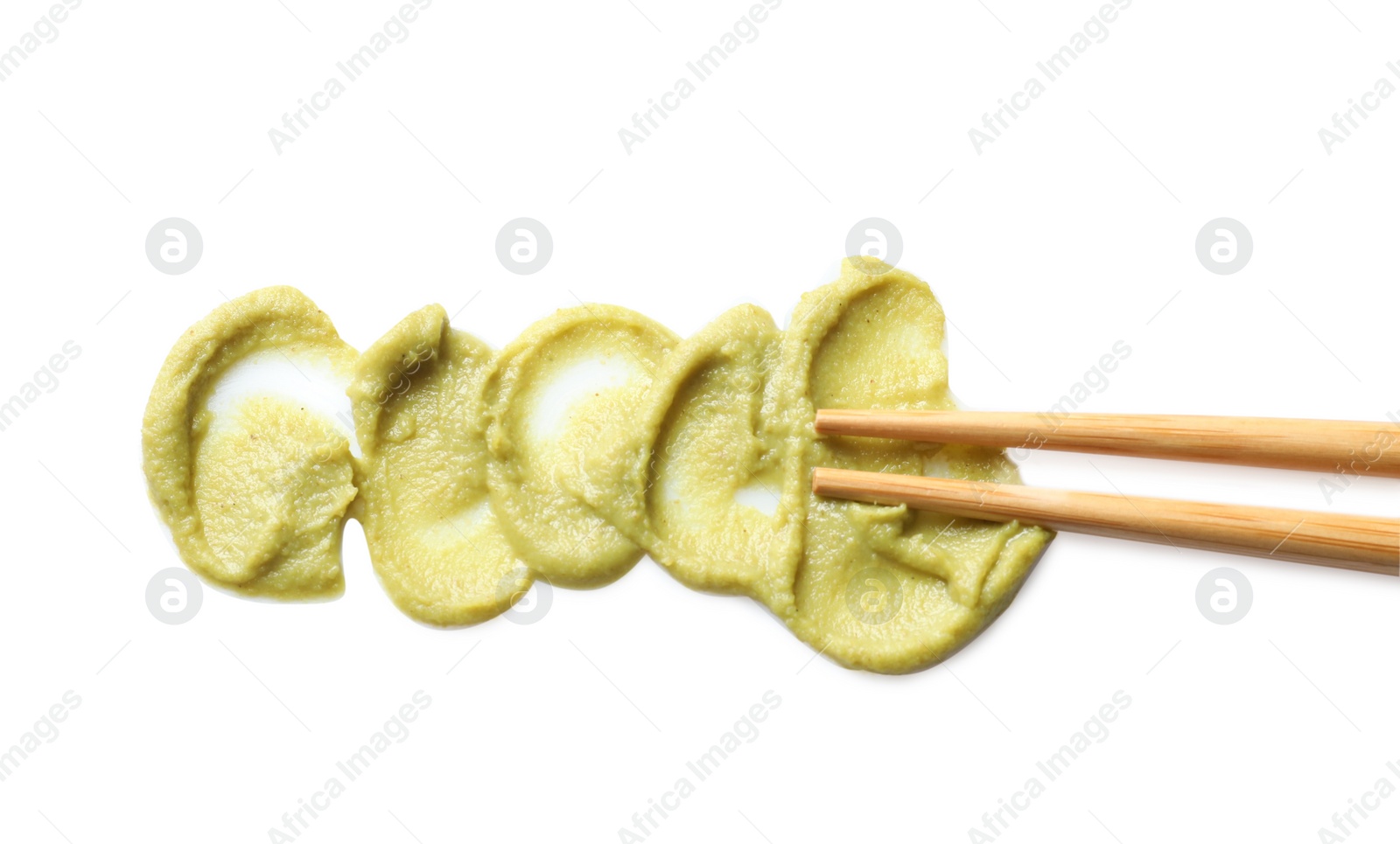 Photo of Delicious spicy wasabi and chopsticks on white background, top view. Traditional sauce