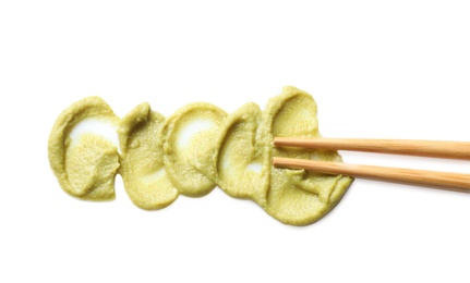 Delicious spicy wasabi and chopsticks on white background, top view. Traditional sauce