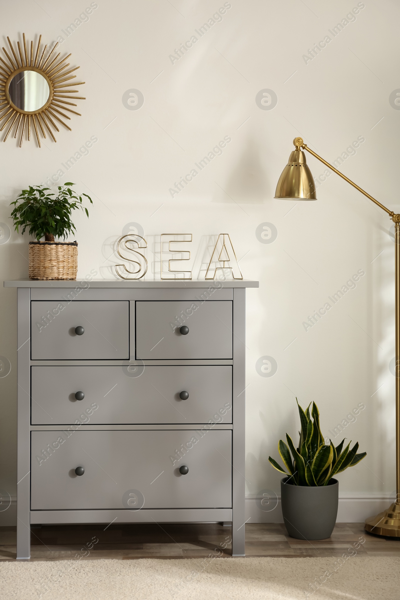 Photo of Grey chest of drawers in stylish room interior