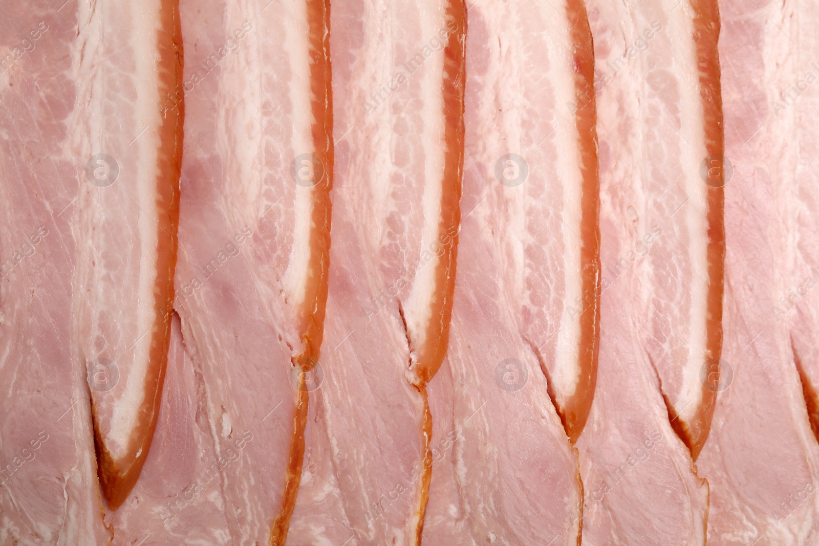 Photo of Slices of delicious smoked bacon as background, closeup