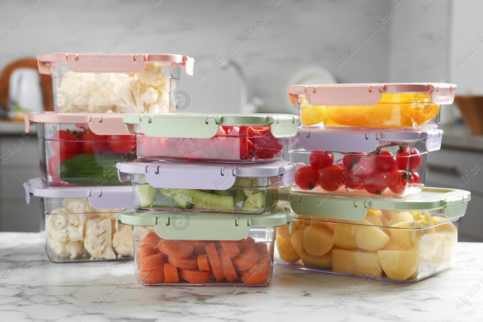 Photo of Boxes with fresh raw vegetables on table in kitchen