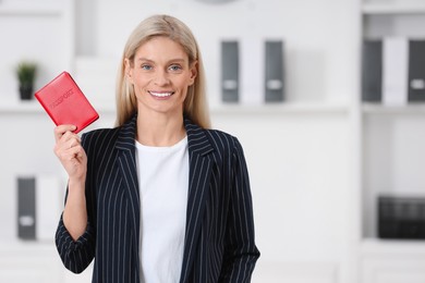 Immigration. Happy woman with passport indoors, space for text