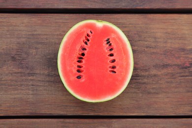 Half of delicious ripe watermelon on wooden table, top view