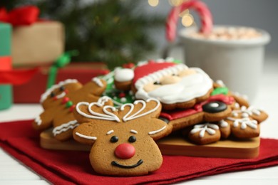 Tasty homemade Christmas cookies on white wooden table, closeup