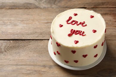 Photo of Bento cake with text Love You on wooden table, space for text. St. Valentine's day surprise