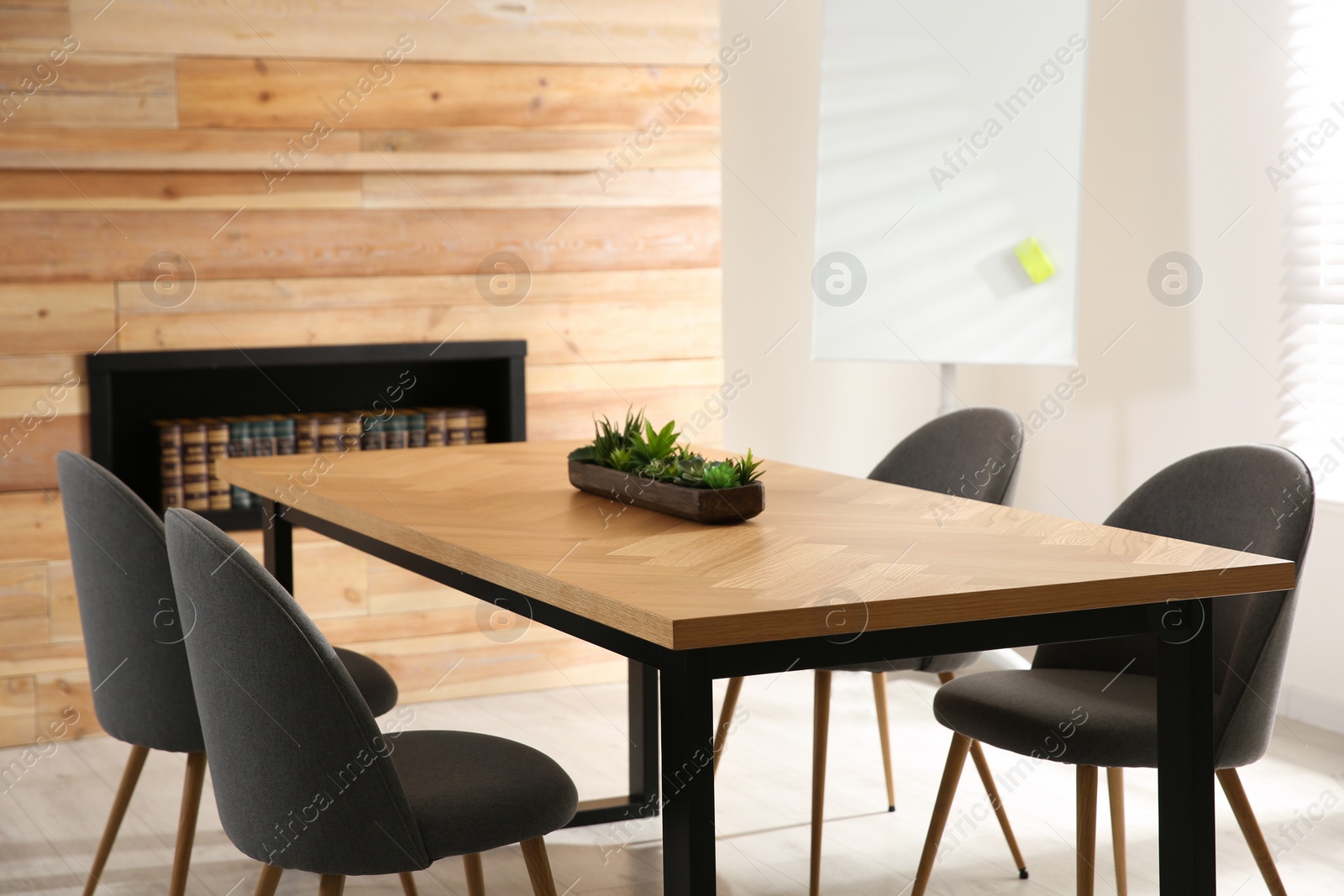 Photo of Modern meeting room interior with large table and chairs