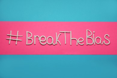 Photo of Hashtag BreakTheBias made of modeling clay on color background, top view