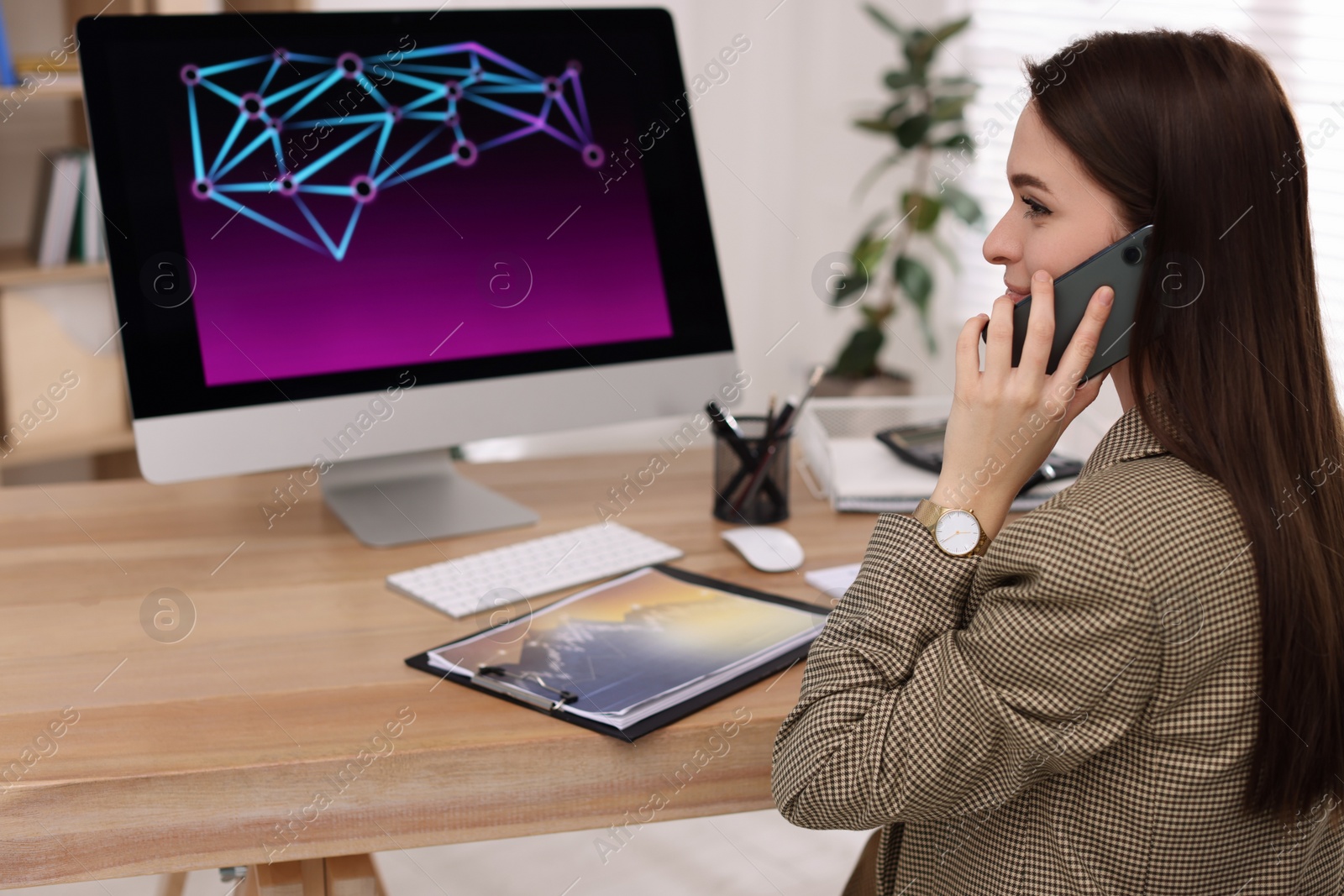 Photo of Businesswoman talking on phone while working in office. Forex trading