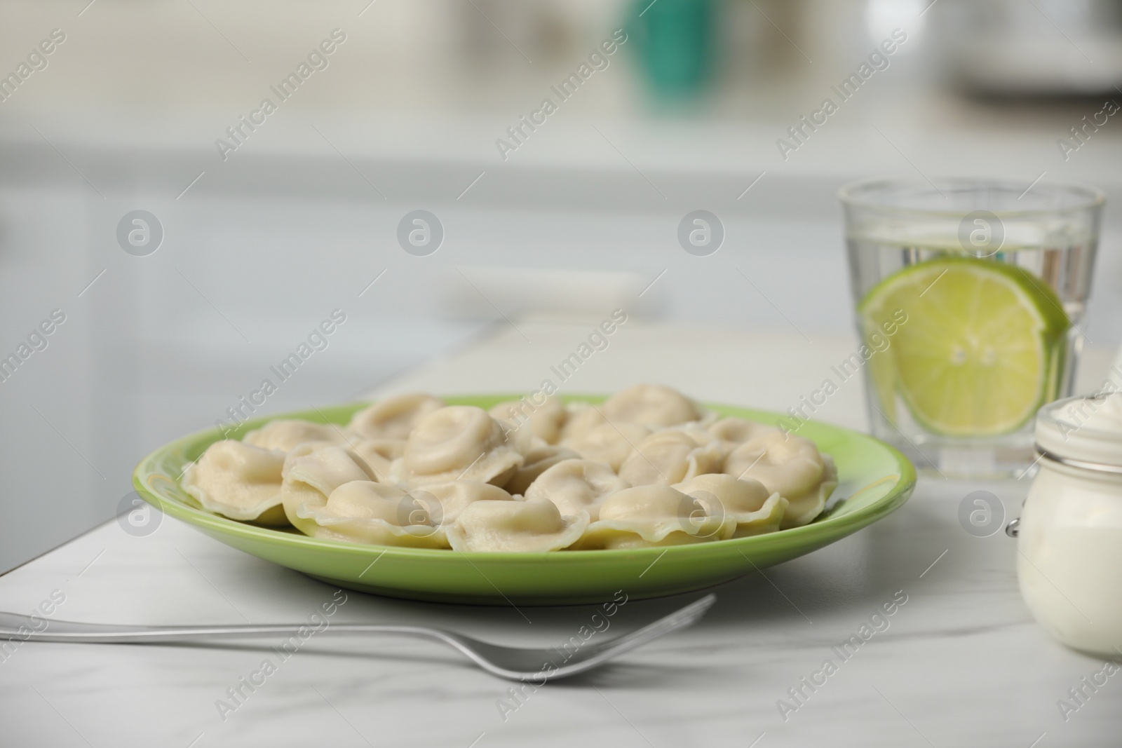 Photo of Delicious dumplings on table in kitchen, closeup