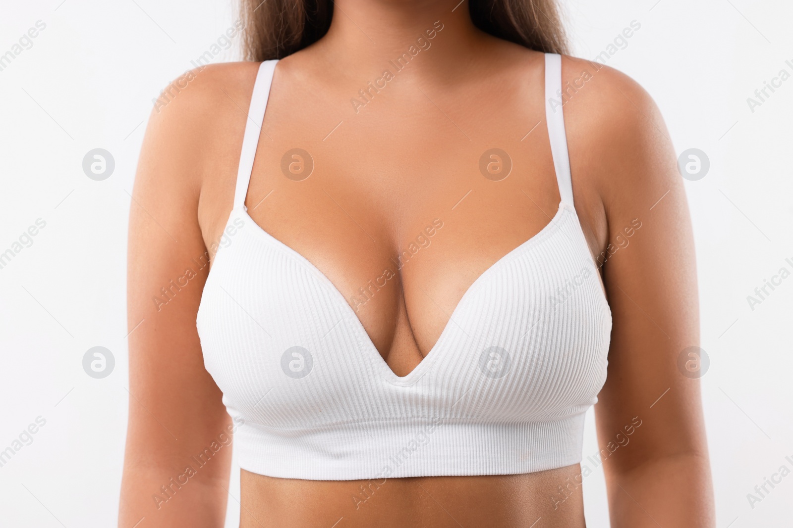 Photo of Woman with beautiful breast on white background, closeup