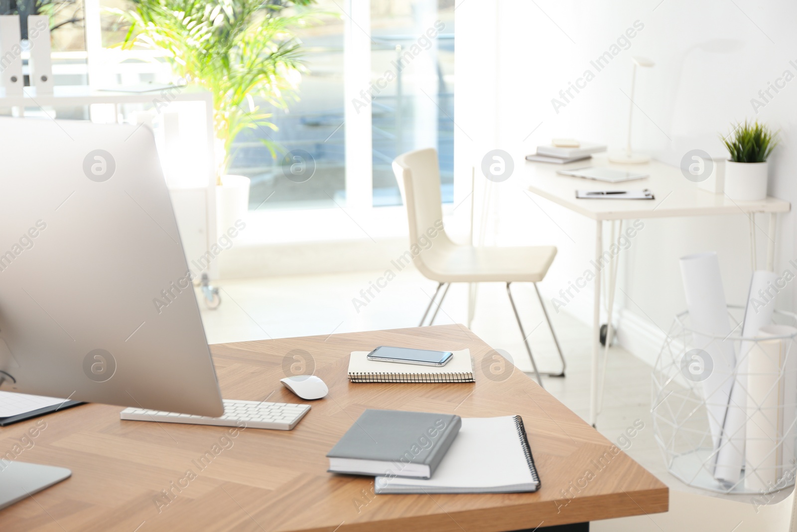 Photo of Computer on desk in modern office. Comfortable workplace