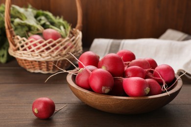 Photo of Bowl with fresh ripe radishes on wooden table